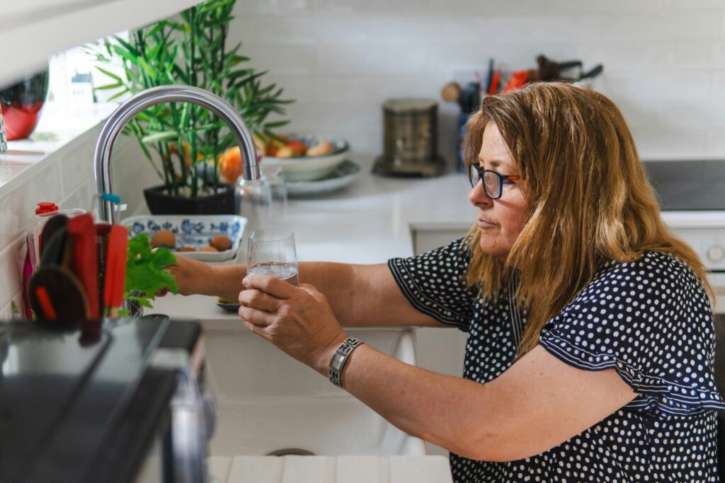 Woman drinking water in the morning to improve energy and hydration